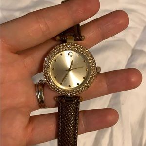 Brown and gold watch with crystal detail